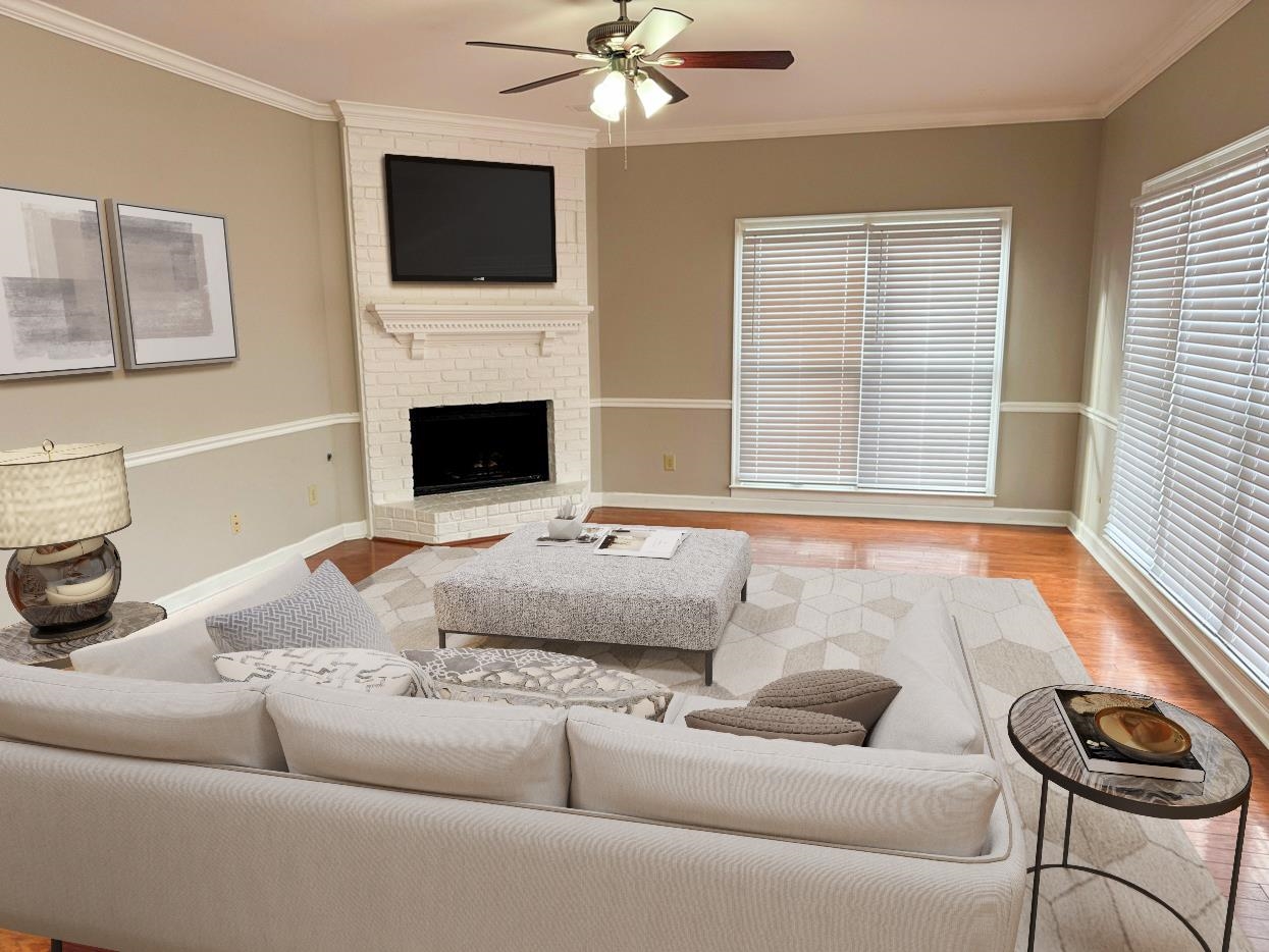 8810 Raspberry Lane Memphis, TN 38016 - Photo 10 of 28 Living room featuring ornamental molding, wood finished floors, and a ceiling fan