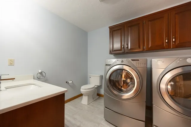 a utility room with sink dryer and washer