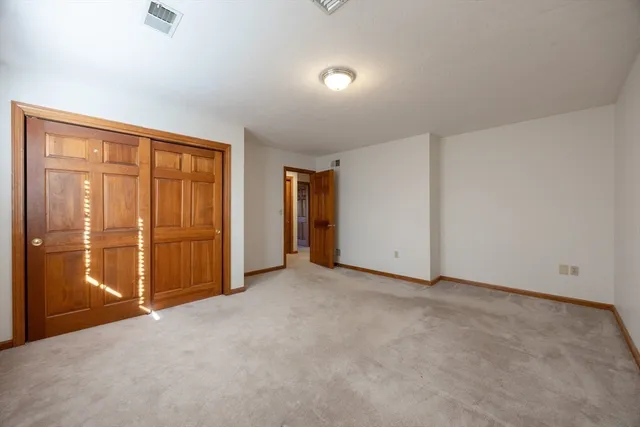 an empty room with closet area