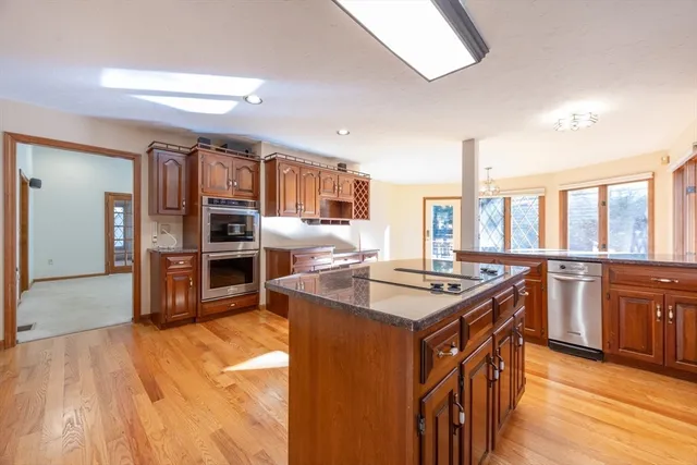 a kitchen with stainless steel appliances granite countertop a stove and a large refrigerator