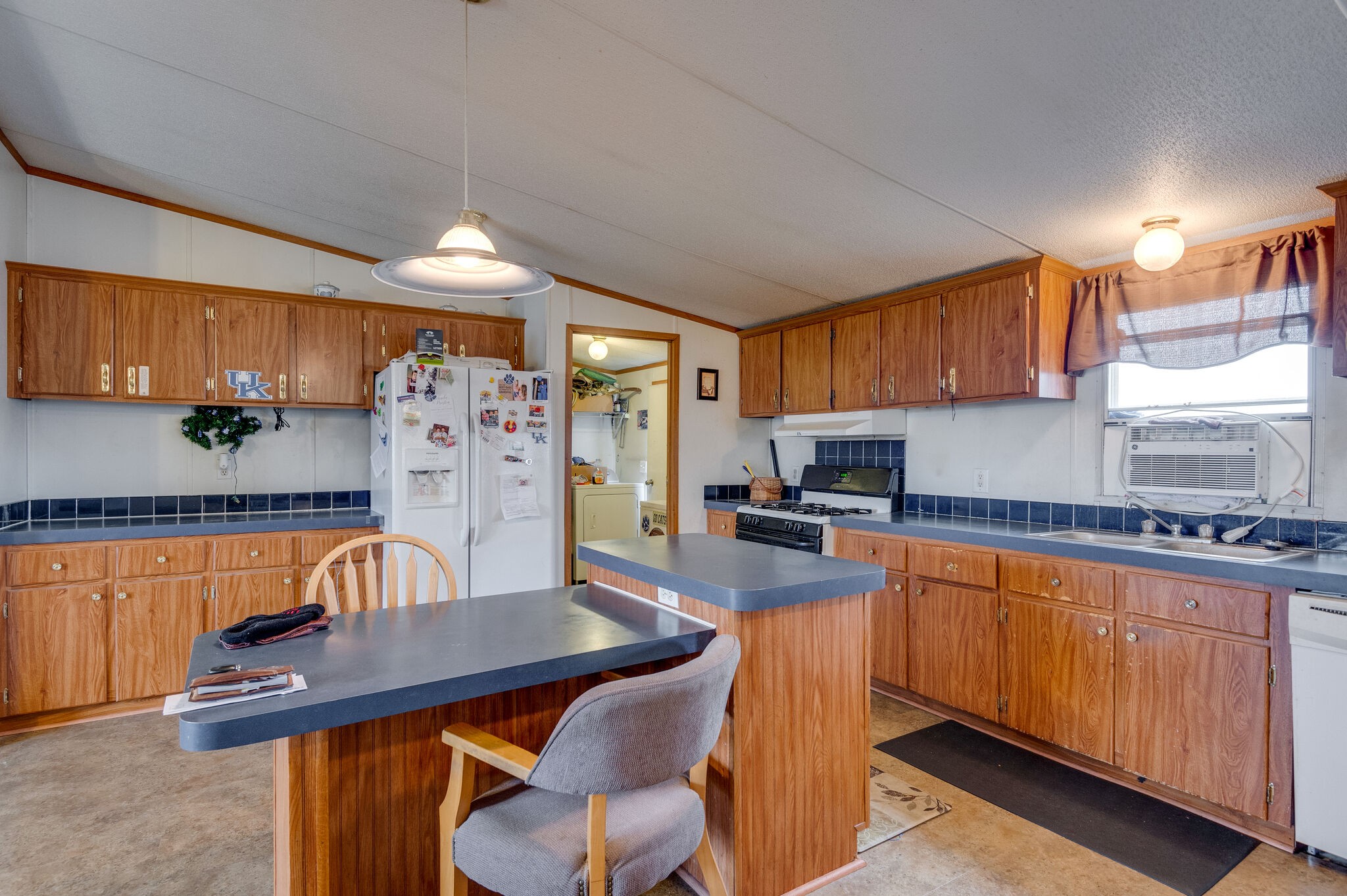 2848 Jack Teasley Road Pleasant View, TN 37146 - Photo 27 of 45 a kitchen with stainless steel appliances granite countertop a stove a sink dishwasher and cabinets with wooden floor