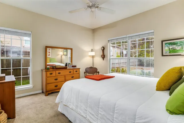 a bedroom with a bed and a large window