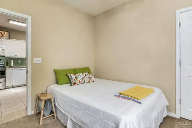 a bedroom with a bed and a painting on the wall