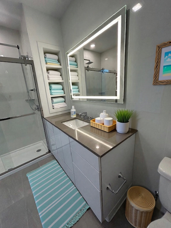 148 Old Post Road, Unit 218 Sharon, MA 02067 - Photo 7 of 17 a bathroom with a granite countertop sink and a mirror
