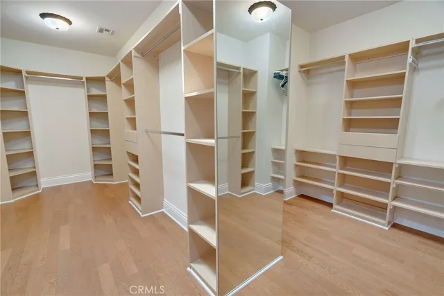 a view of an empty room with furniture and entryway