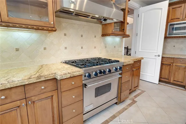 a kitchen with stainless steel appliances granite countertop a stove and a refrigerator