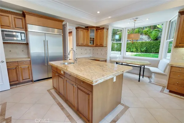 a kitchen with a stove a sink and a dining table