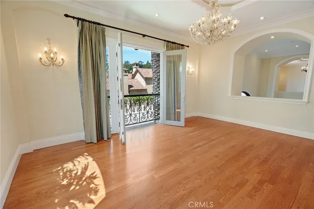 a view of empty room with wooden floor and fireplace
