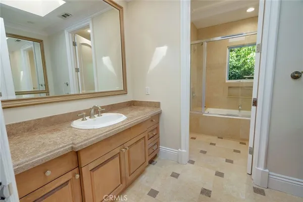 a bathroom with a sink a mirror and a shower