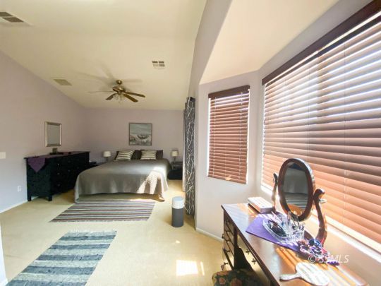 1109 Rebecca Avenue Ridgecrest, CA 93555 - Photo 35 of 50 a bedroom with a bed and a chair