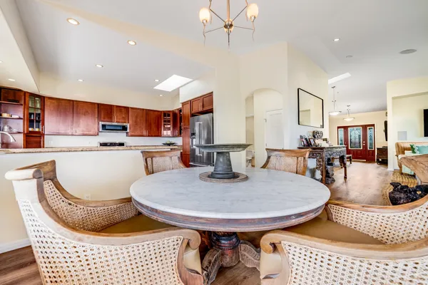 a kitchen with a table chairs a dining table and chairs