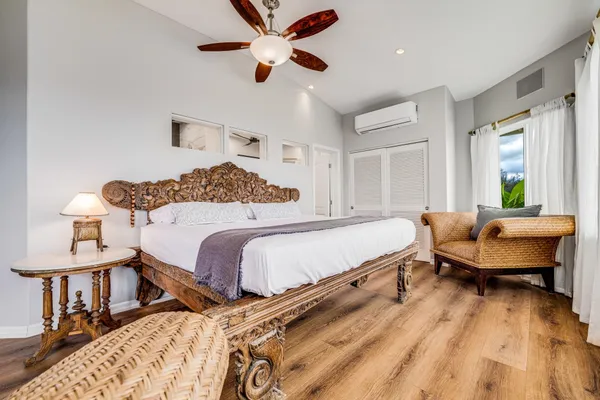 a bedroom with a bed and wooden floor