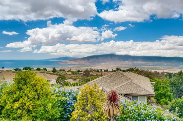 an aerial view of a houses with a yard