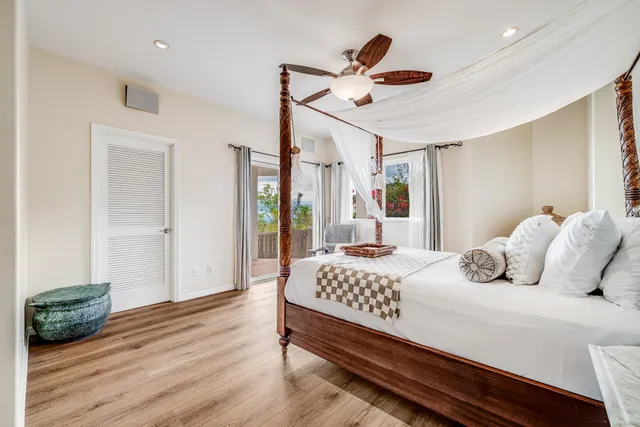 a bedroom with bed and wooden floor