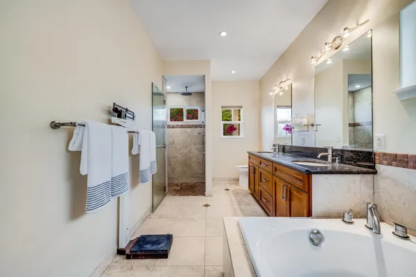 a large bathroom with a tub a sink and a shower