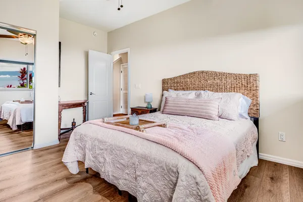 a bedroom with a bed and wooden floor