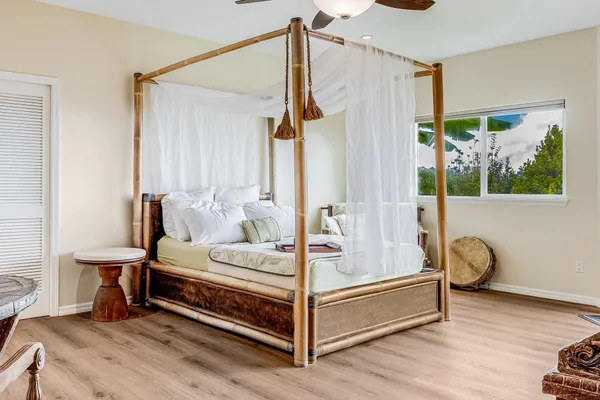 a bed room with a bed and a chair