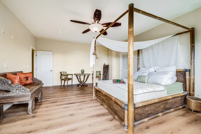 a bedroom with furniture and wooden floor