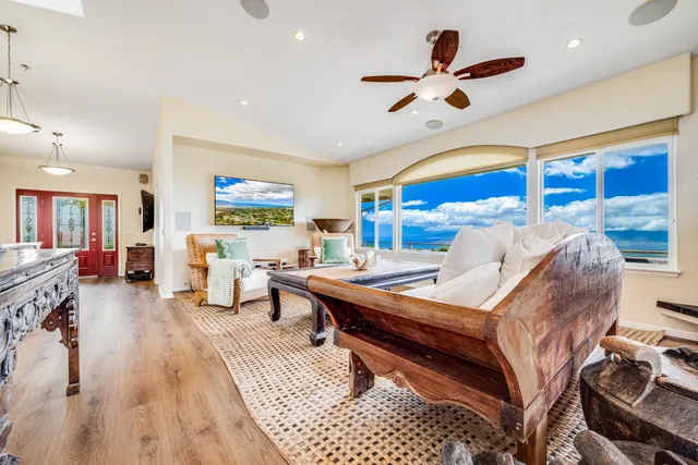 a living room with furniture a rug and a large window