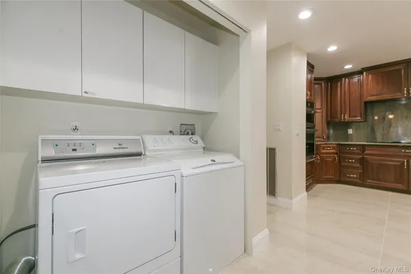 a kitchen with granite countertop wooden cabinets stainless steel appliances a sink and a window