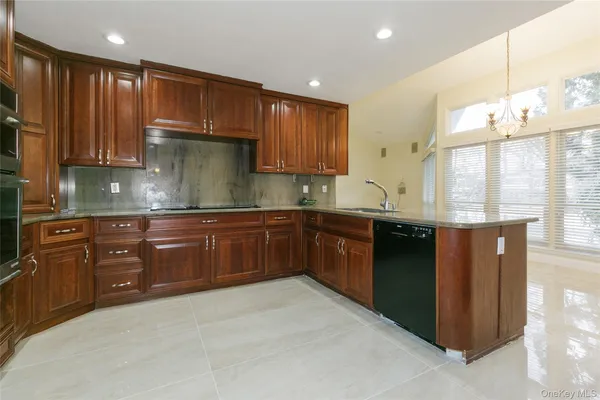 a kitchen with stainless steel appliances granite countertop a refrigerator a sink and a stove