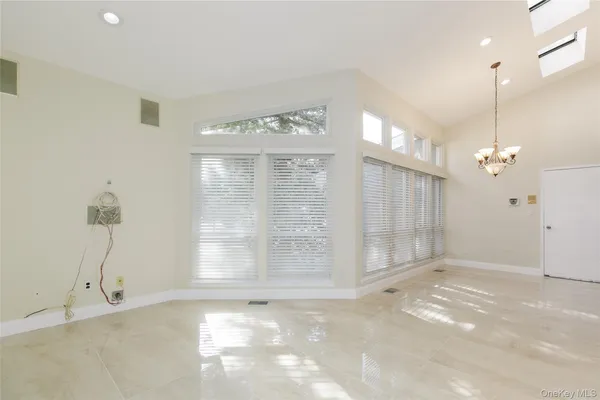 a spacious bathroom with a tub sink shower and mirror