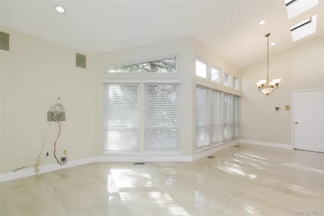 a spacious bathroom with a tub sink shower and mirror