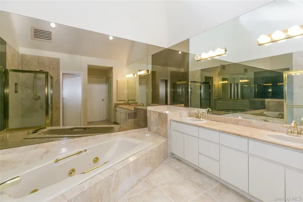 a bathroom with a tub sink and shower