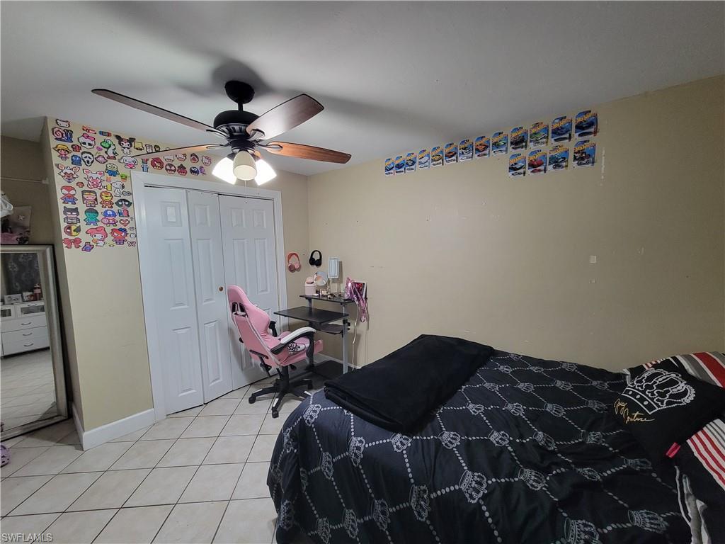 10 East Jersey Road Lehigh Acres, FL 33936 - Photo 11 of 32 Bedroom featuring a closet, light tile patterned flooring, ceiling fan, and baseboards