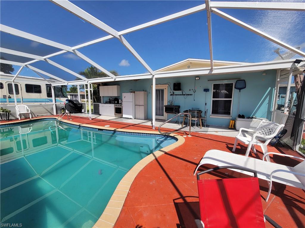 10 East Jersey Road Lehigh Acres, FL 33936 - Photo 24 of 32 Pool featuring glass enclosure and a patio