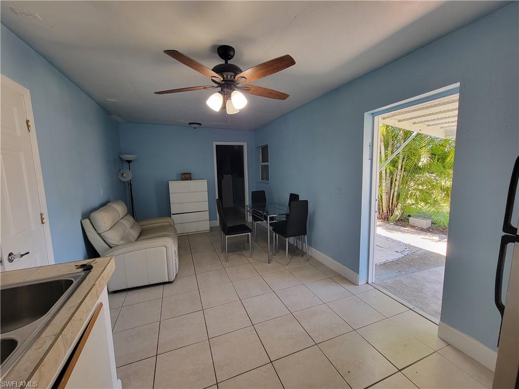 10 East Jersey Road Lehigh Acres, FL 33936 - Photo 25 of 32 Living room with light tile patterned floors, ceiling fan, and baseboards