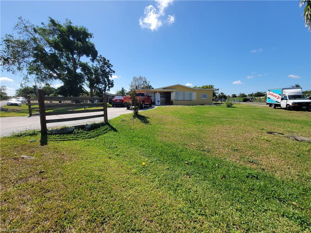 10 East Jersey Road Lehigh Acres, FL 33936 - Photo 3 of 32 View of yard with driveway