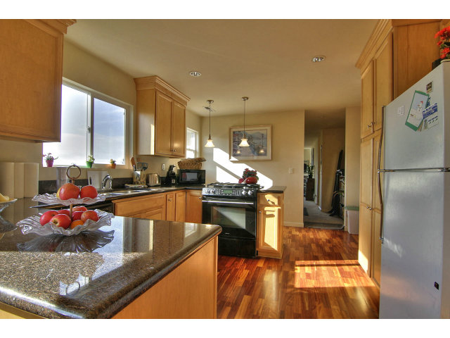 1289 Trinity Avenue Seaside, CA 93955 - Photo 3 of 13 a kitchen with stainless steel appliances granite countertop a sink refrigerator and cabinets