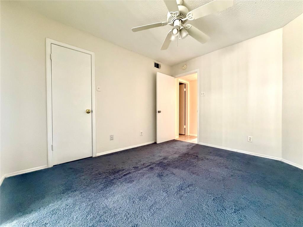18333 Roehampton Drive, Unit 624 Dallas, TX 75252 - Photo 12 of 39 an empty room with a ceiling fan and a window