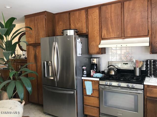 6405 Keystone Street Simi Valley, CA 93063 - Photo 11 of 17 a kitchen with stainless steel appliances granite countertop a refrigerator a stove a sink and a counter space