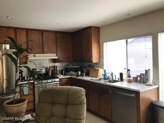 6405 Keystone Street Simi Valley, CA 93063 - Photo 12 of 17 a kitchen with a sink appliances cabinets and a window