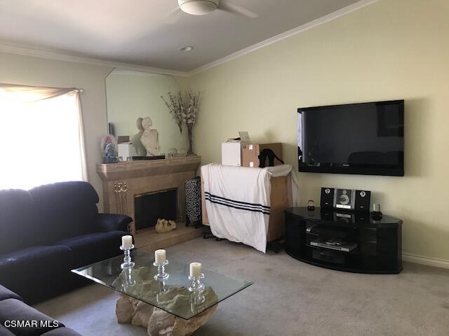 6405 Keystone Street Simi Valley, CA 93063 - Photo 5 of 17 a living room with furniture a flat screen tv and a fireplace