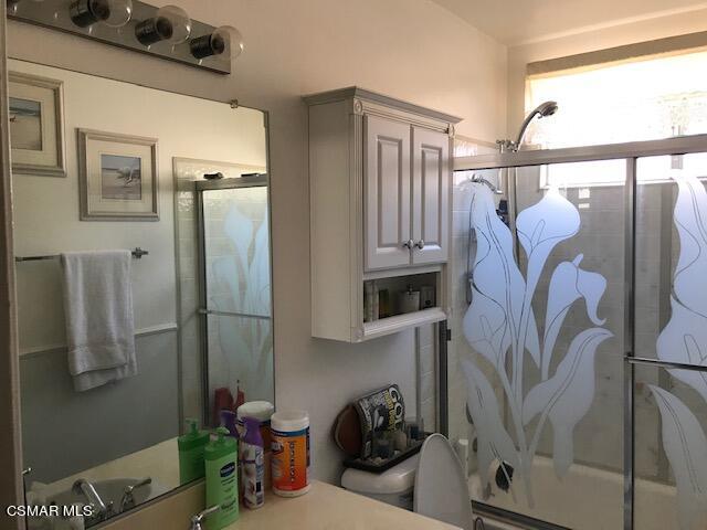 6405 Keystone Street Simi Valley, CA 93063 - Photo 7 of 17 a bathroom with a sink and mirror with toilet
