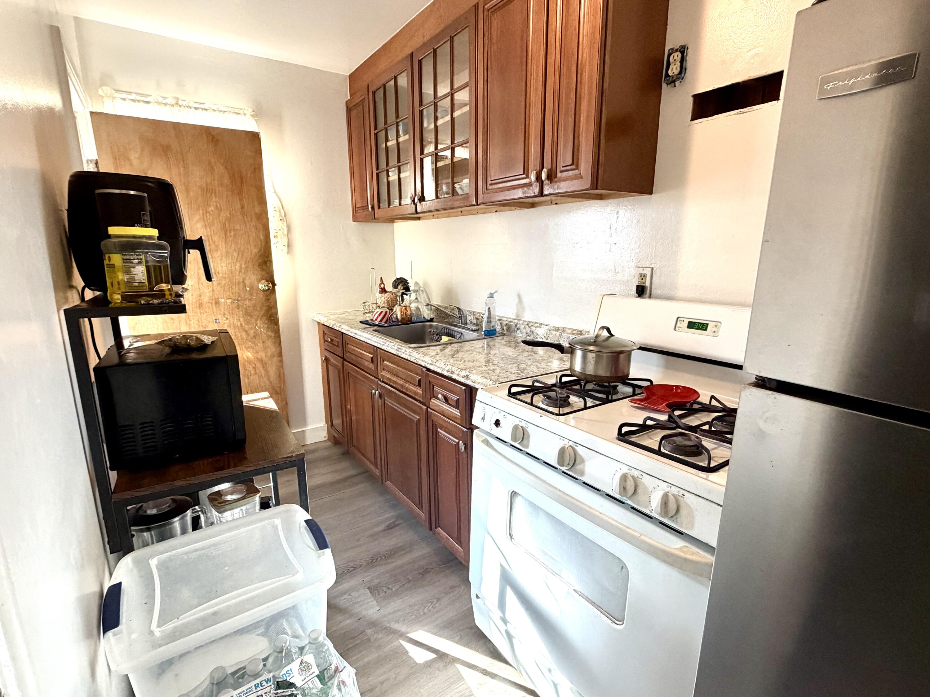 10 Hiramar Road, Unit 1012 Hyannis, MA 02601 - Photo 5 of 7 a kitchen with stainless steel appliances granite countertop a stove a sink and a refrigerator