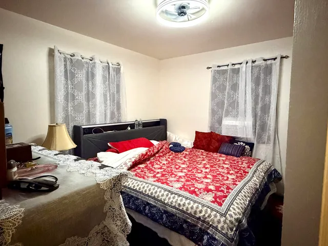 a bedroom with a bed and dresser