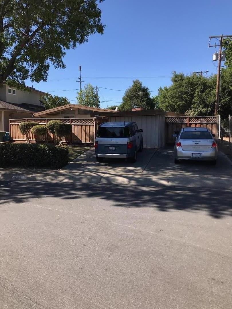 a view of house with outdoor space and sitting area