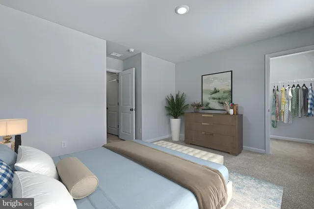 a bedroom with a bed and a couch