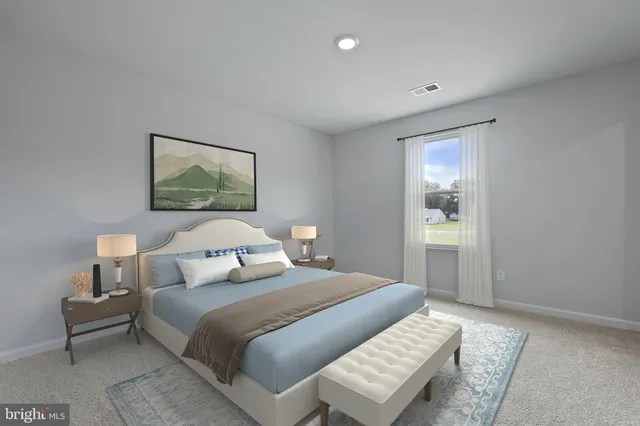 a bedroom with a bed and a painting on the wall