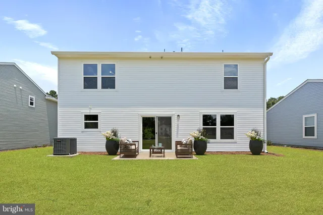 a view of a house with a backyard and a patio
