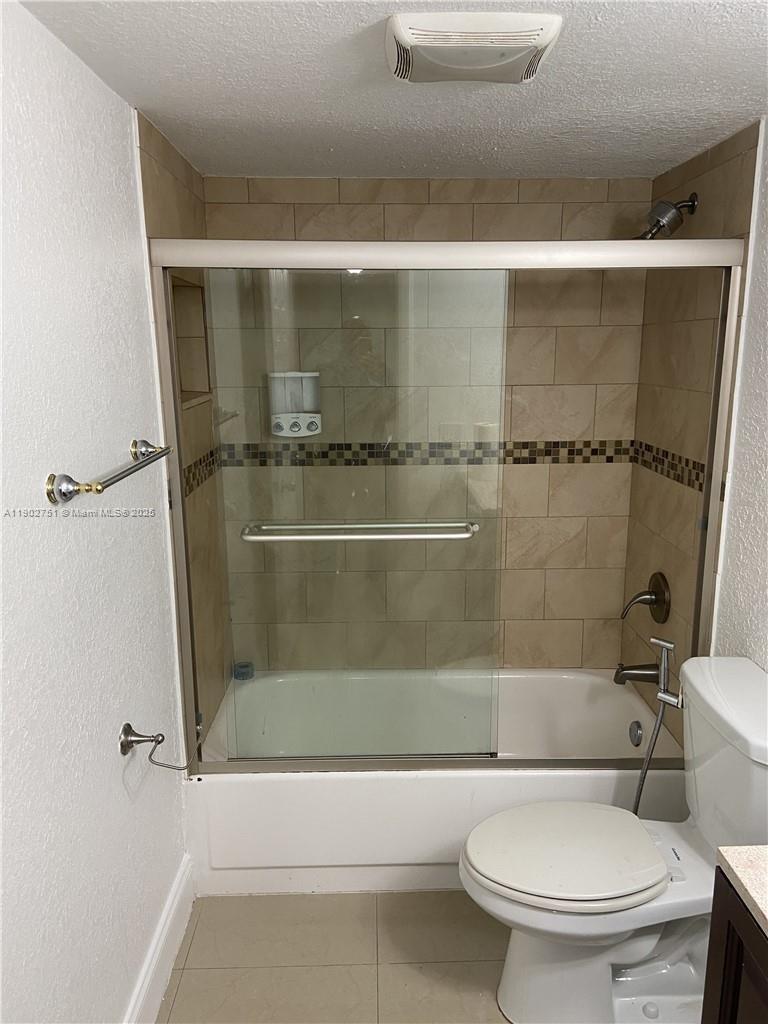 3955 North Nob Hill Road, Unit 101 Sunrise, FL 33351 - Photo 13 of 19 a bathroom with a toilet and a shower