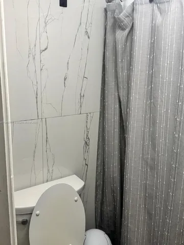 a white toilet sitting next to a bathroom sink