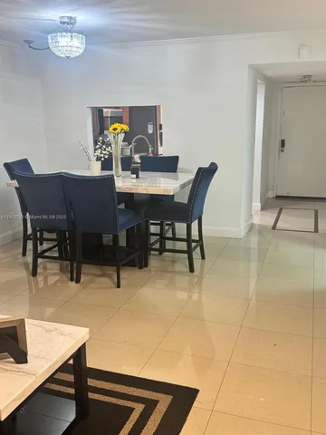 a dining room with furniture and chandelier