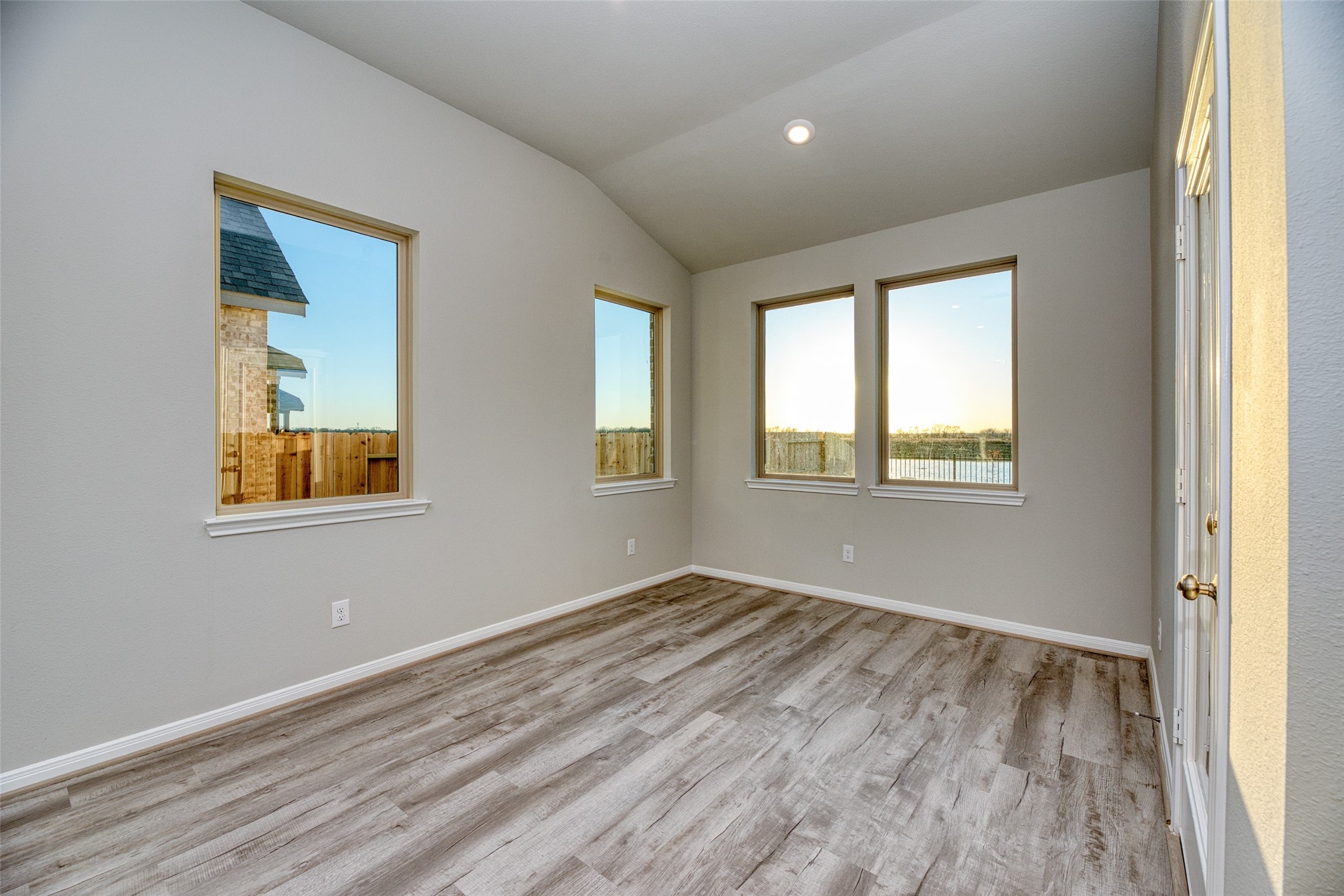 21122 Sunlight Grv Drive Rosharon, TX 77583 - Photo 23 of 45 a view of an empty room with wooden floor and a window