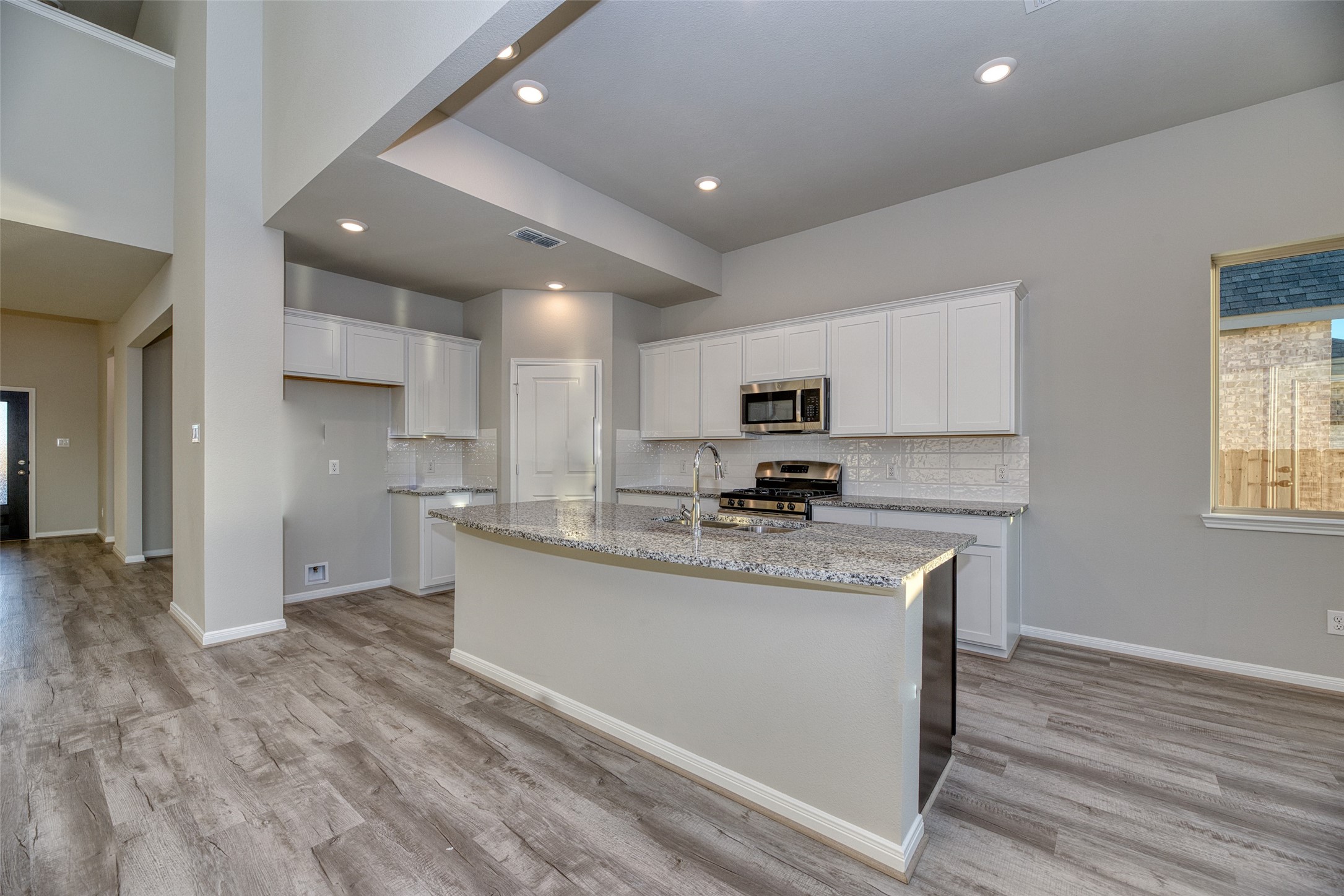 21122 Sunlight Grv Drive Rosharon, TX 77583 - Photo 8 of 45 a kitchen with stainless steel appliances granite countertop a sink a stove a refrigerator cabinets and a center island