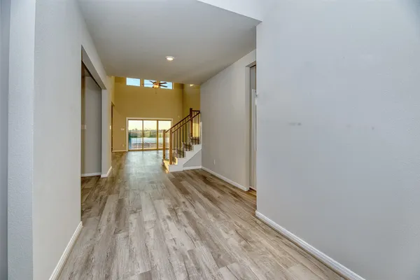 a view of empty room with wooden floor